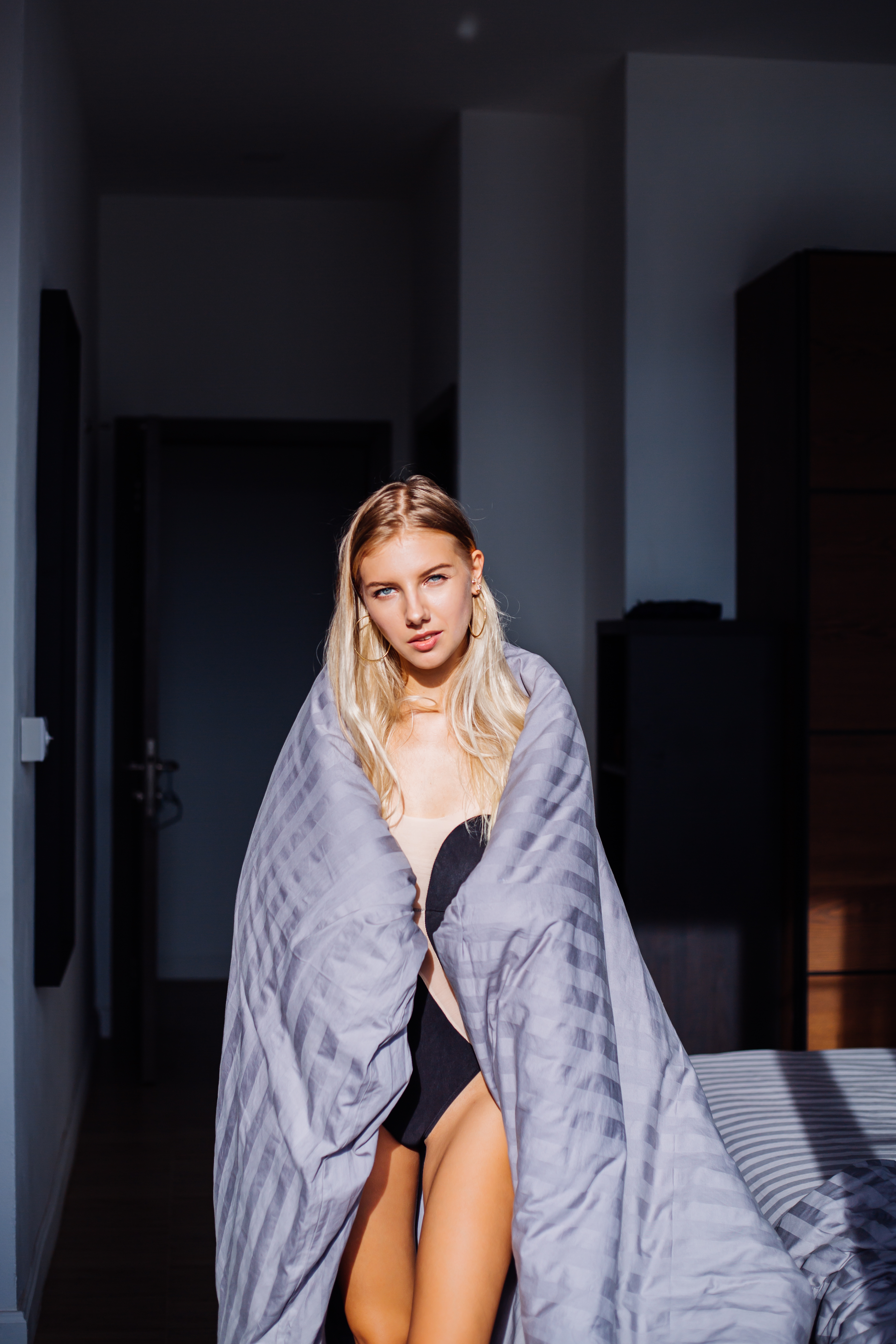 portrait-happy-calm-woman-bedroom-gray-stripped-blanket-black-beige-body-home-sleep-wear.jpg